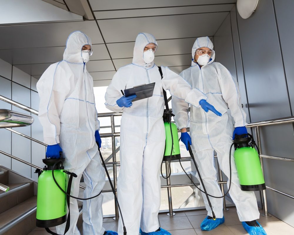 Protect your country from covid 19, coronavirus. Men in protective suits deciding what to disinfect with spray